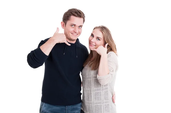 Couple smiling and posing making call me gesture — Stock Photo, Image