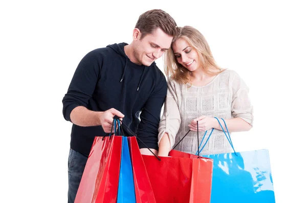 Couple looking in shopping bags and smiling Stock Picture
