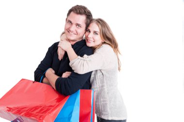 Grup alışveriş torbaları tutan adamı kucaklayan kadın