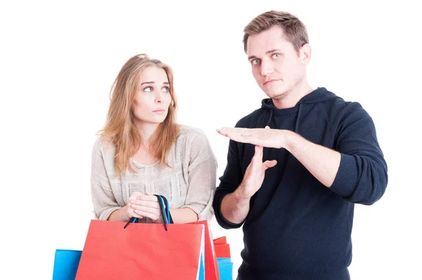 Man making time out gesture to woman holding shopping bags — Stock Photo, Image
