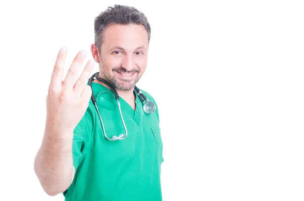 Handsome medic showing three fingers — Stock Photo, Image