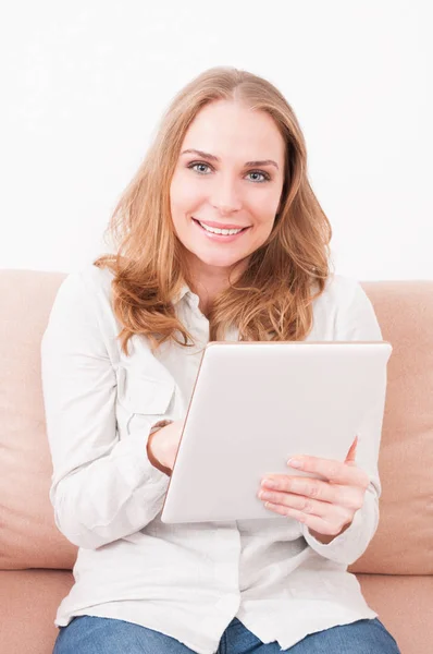 Pretty lady staying on sofa surfing on tablet — Stock Photo, Image