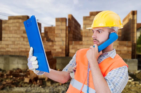 Professional constructor reading something — Stock Photo, Image