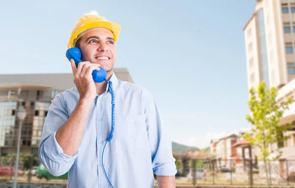 Smiling engineer with protection helmet