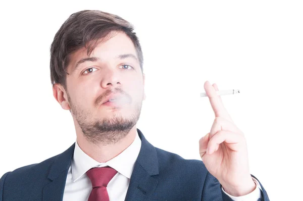 Man wearing suit blowing smoke from a cigarette — Stock Photo, Image