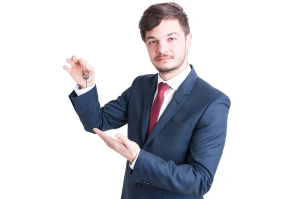 Real estate agent wearing suit showing keying — Stock Photo, Image