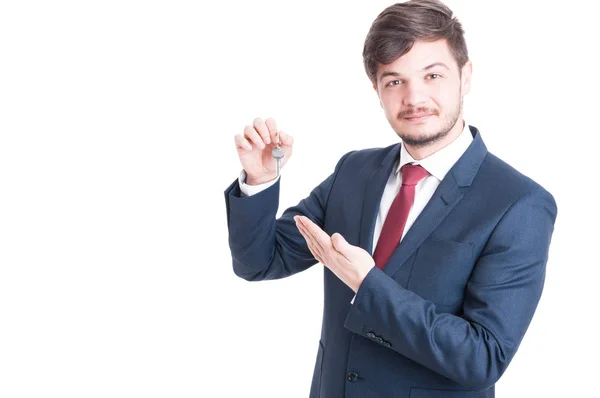 Real estate agent wearing suit showing keying — Stock Photo, Image