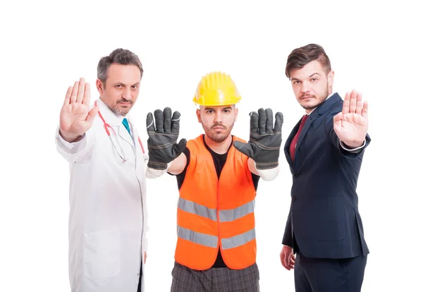 Medic with constructor and businessman showing stop sign — Stock Photo, Image