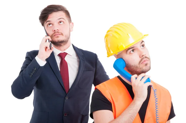 Бизнесмен и инженер разговаривают по мобильному телефону — стоковое фото