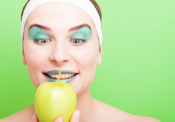 Closeup portrait of young beautiful woman holding apple