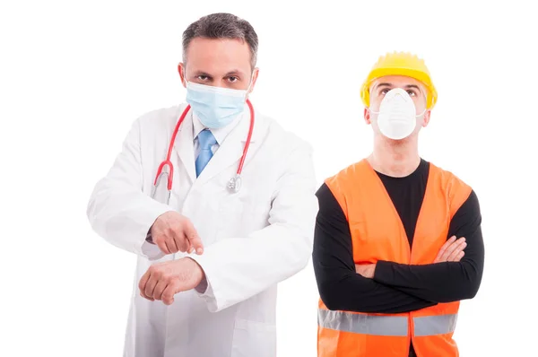 Doctor showing time and constructor ignoring it — Stock Photo, Image