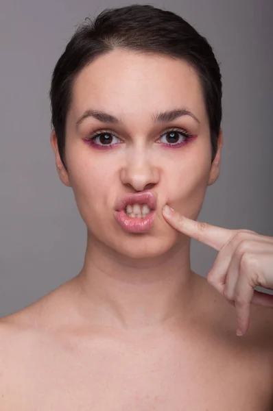 Playful pretty girl touching her cheek — Stock Photo, Image