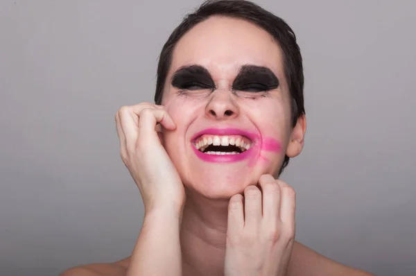 Smiling young woman with smeared makeup — Stock Photo, Image