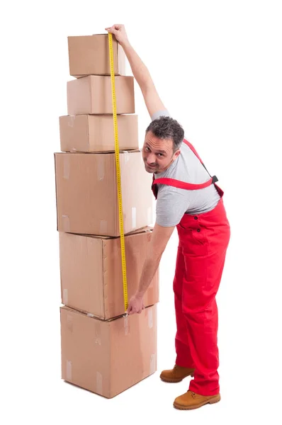 Full body of mover man measuring bunch of boxes — Stock Photo, Image