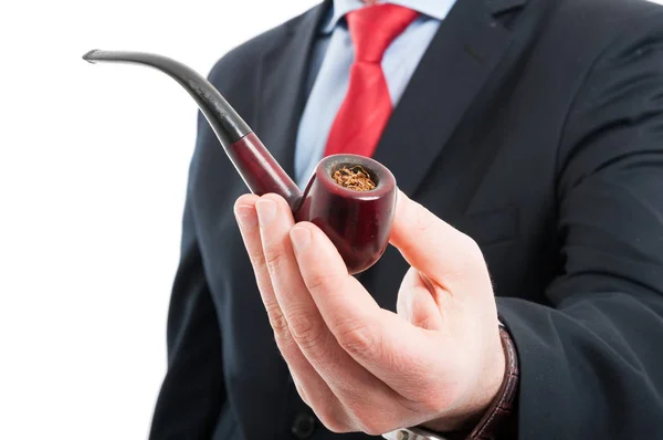 Close-up of man holding a pipe showing tobacco — Stock Photo, Image