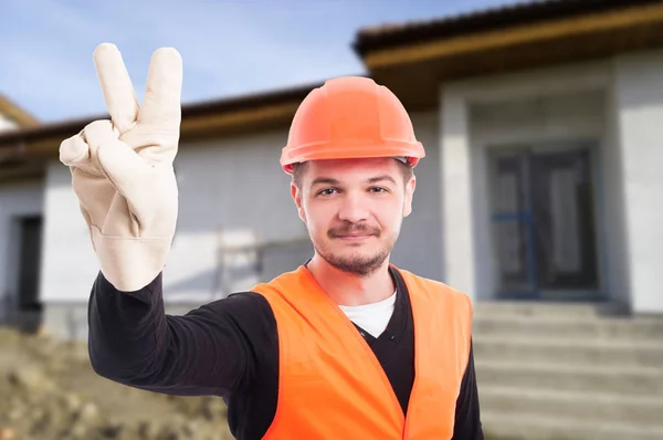 Gelukkig man met helm met twee vingers — Stockfoto