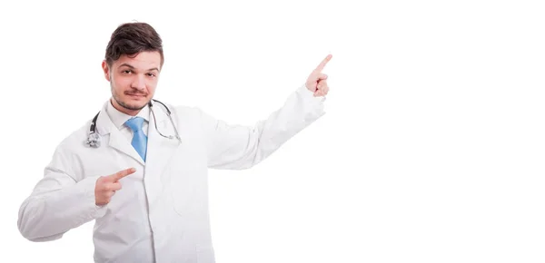 Smiley medical doctor pointing at something — Stock Photo, Image