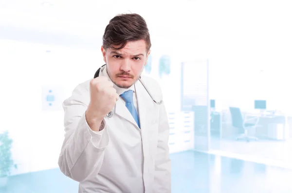 Male doctor acting aggressive and showing his fist — Stock Photo, Image