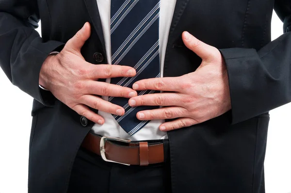 Close-up of elegant man holding his stomach like hurting — Stock Photo, Image