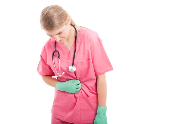 Enfermera sosteniendo su estómago como herida —  Fotos de Stock