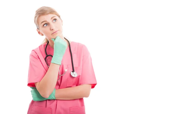 Attractive medical nurse making thinking gesture Stock Image