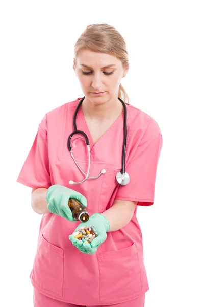 Lady medical nurse spilling a bottle of pills — Stock Photo, Image