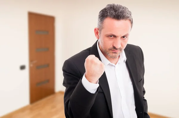 Angry realtor threaten with a fist rised up — Stock Photo, Image