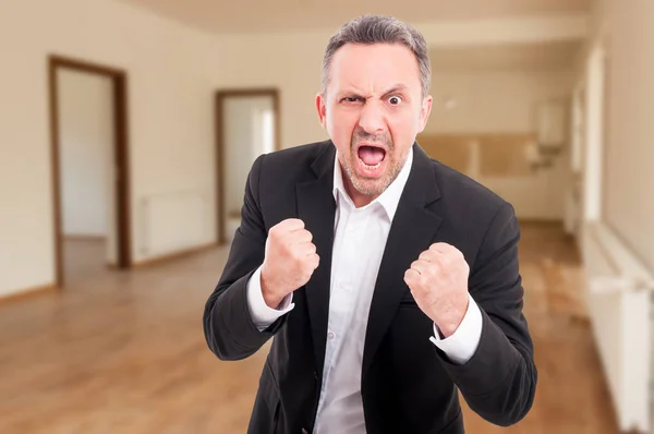 Angry real estate agent clutching fists and shouting — Stock Photo, Image