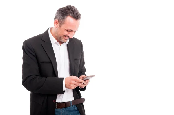 Jovem empresário feliz lendo mensagem de texto no celular — Fotografia de Stock