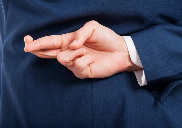 Closeup of man hand doing a cheating gesture Stock Photo