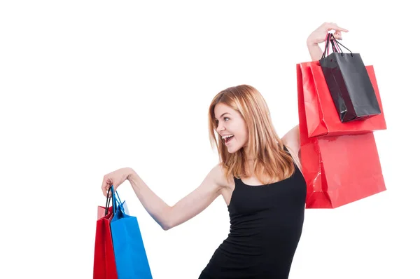 Cheerful shopper girl with colorful bags — Stock Photo, Image