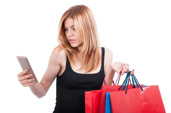 Pretty blonde girl browsing something on cellphone — Stock Photo, Image