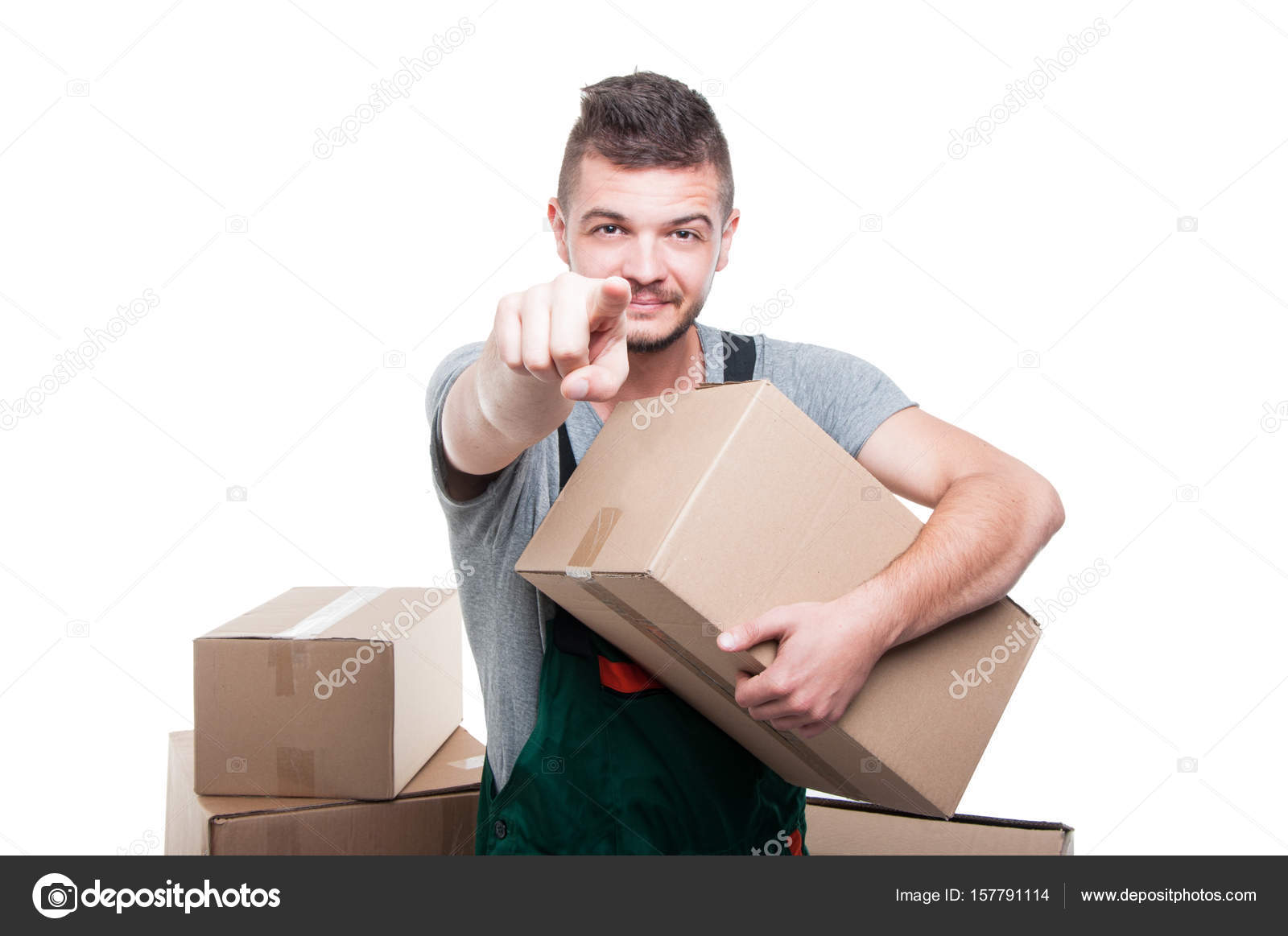 Mover Guy Holding Cardboard Box Pointing Camera Stock Photo