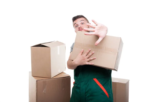 Mover man holding cardboard box gesturing stop — Stock Photo, Image