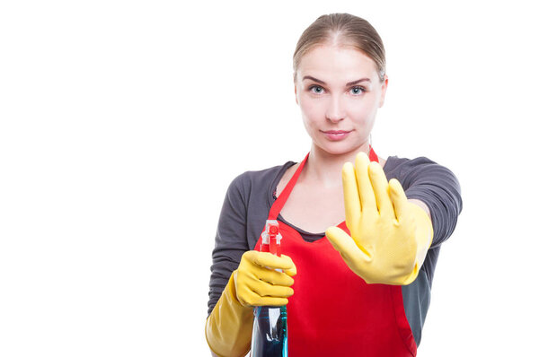 Pretty young housekeeper doing stop gesture