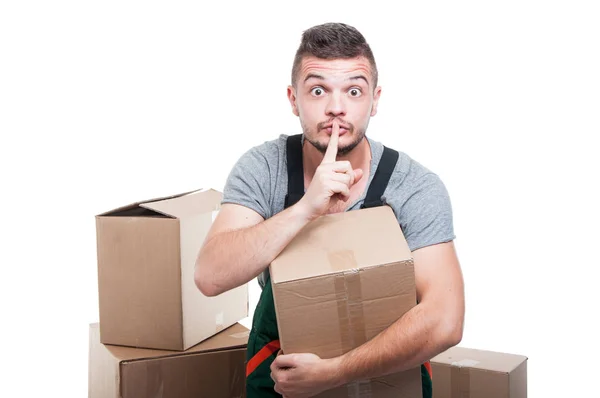 Mover guy holding cardboard box making silence gesture — Stock Photo, Image