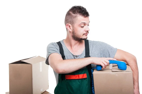 Mover man holding cardboard box putting dow telephone receiver — Stock Photo, Image