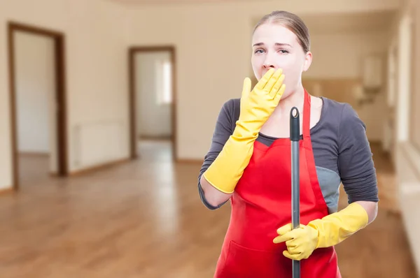 Attractive young housemaid being tired and yawning — Stock Photo, Image