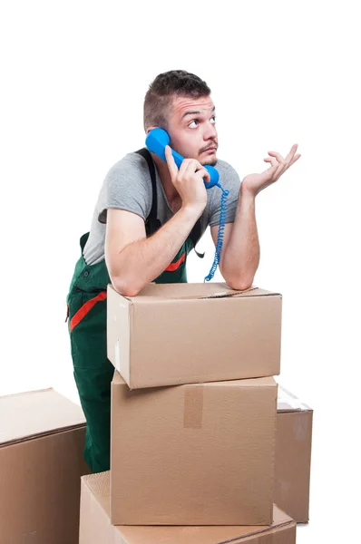 Mover man talking at phone and gesturing — Stock Photo, Image