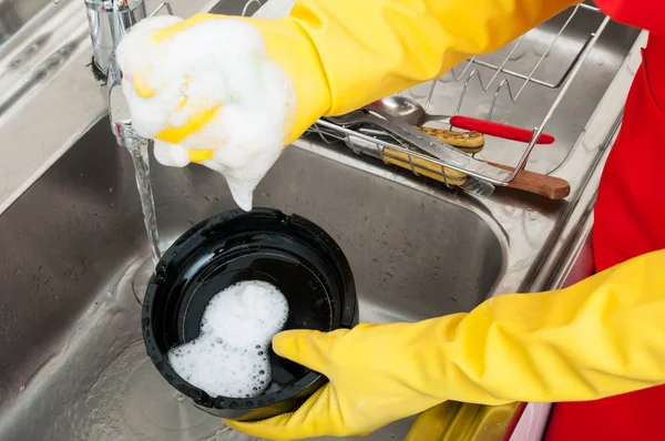 Close-up of housekeeper holding dirty ashtray — Stock Photo, Image