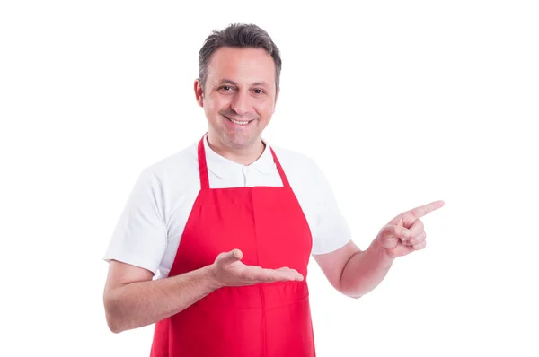 Handsome store employee indicate to the left — Stock Photo, Image