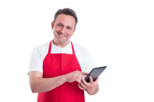 Supermarket clerk using touch screen tablet at work — Stock Photo, Image