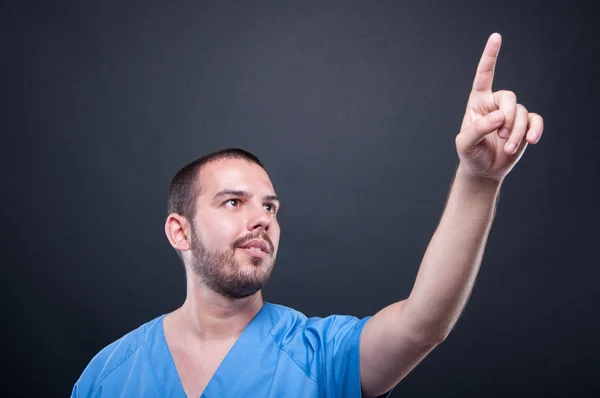 Man medical nurse wearing scrubs using invisible touchscreen — Stock Photo, Image