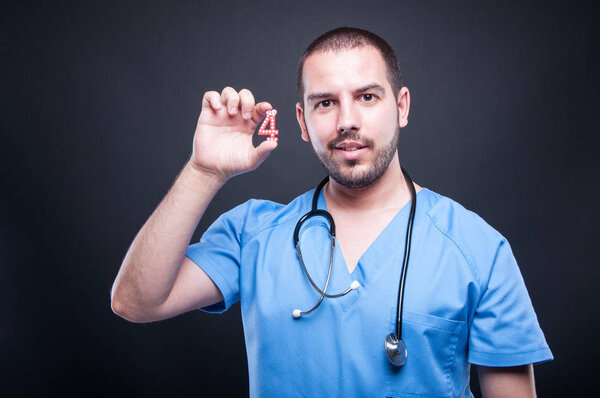 Portrait of male pediatrician showing number four and smiling