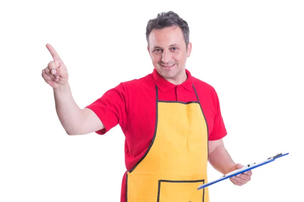 Friendly employee with clipboard pointing the screen — Stock Photo, Image