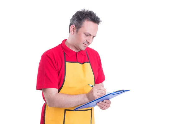 Hypermarket seller looking over products checklist — Stock Photo, Image