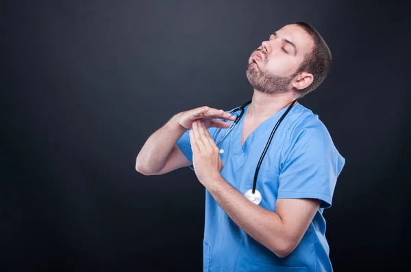 Tired doctor wearing scrubs making time out gesture — Stock Photo, Image