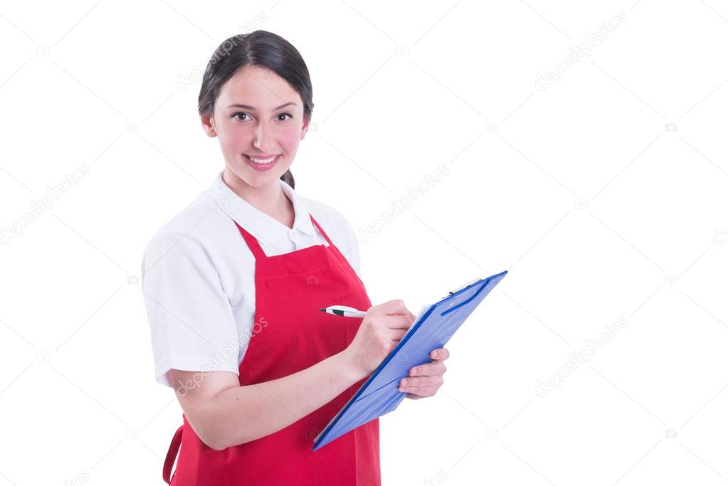 Hardworking female seller taking notes on clipboard