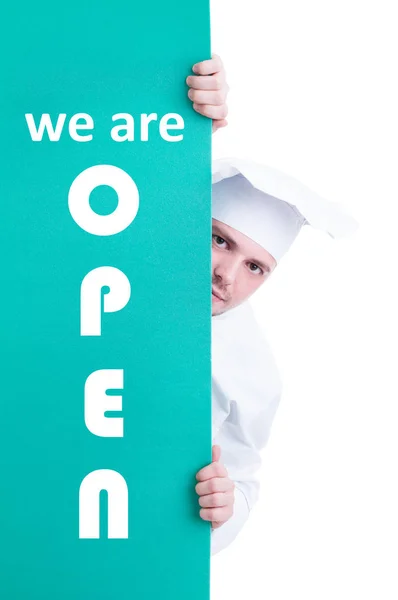 Cook chef holding store opening signboard — Stock Photo, Image