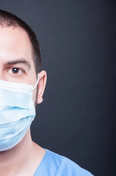 Close-up half face of doctor wearing scrubs and sterile mask — Stock Photo, Image